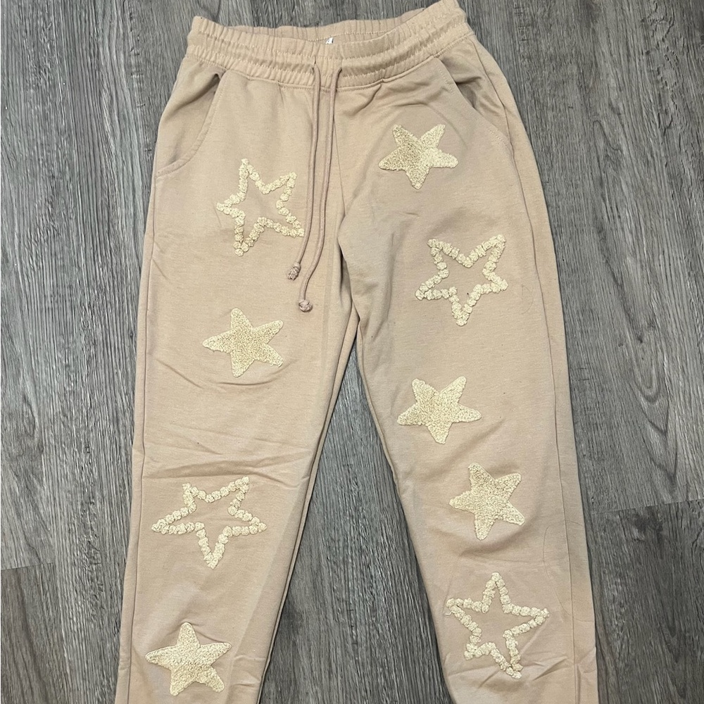 Tan sweatpants with stars. Size S